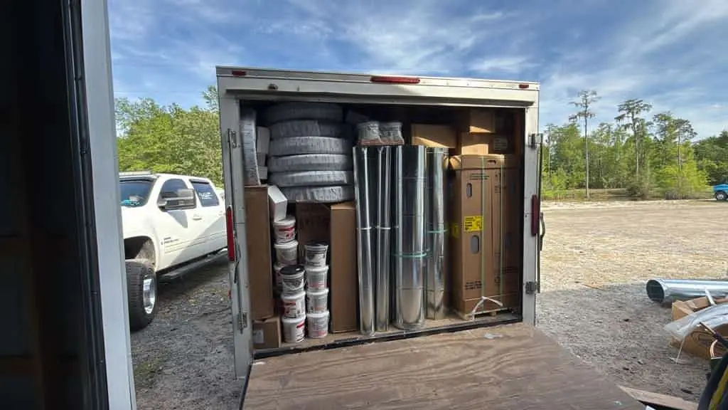 Ventura trailer loaded with duct coils next to the work truck