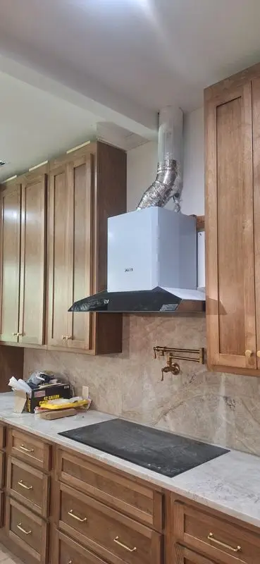 White range hood vented outdoors in a custom Georgia kitchen