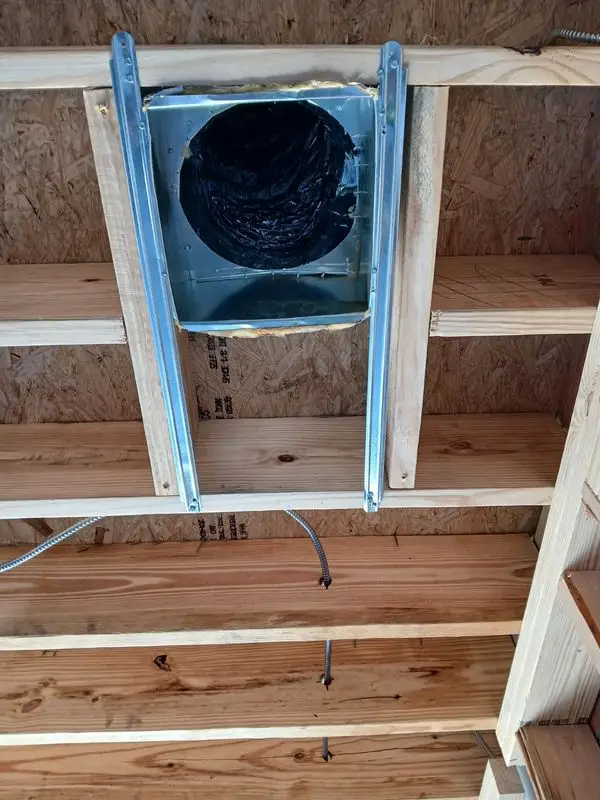 Dryer vent duct roughed in between floor joists